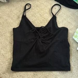 black crop top with small holes in middle ( can be tightened )